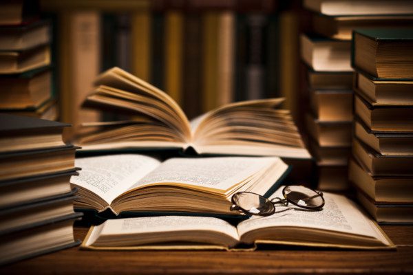 Opened book, lying on the bookshelf