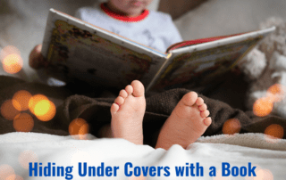 Hiding under covers with a book